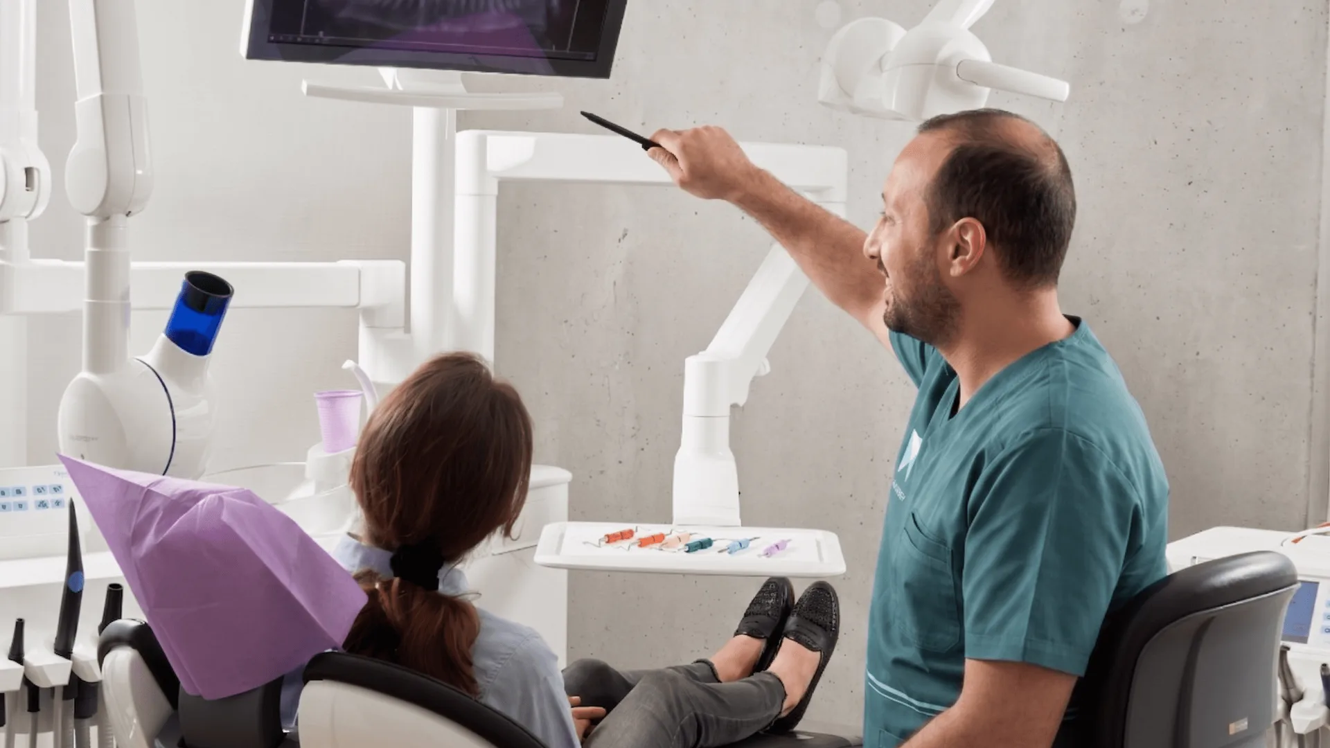 Dr. Khaled Hamarneh explaining a treatment plan to a patient at his dental clinic in Khalda, Amman